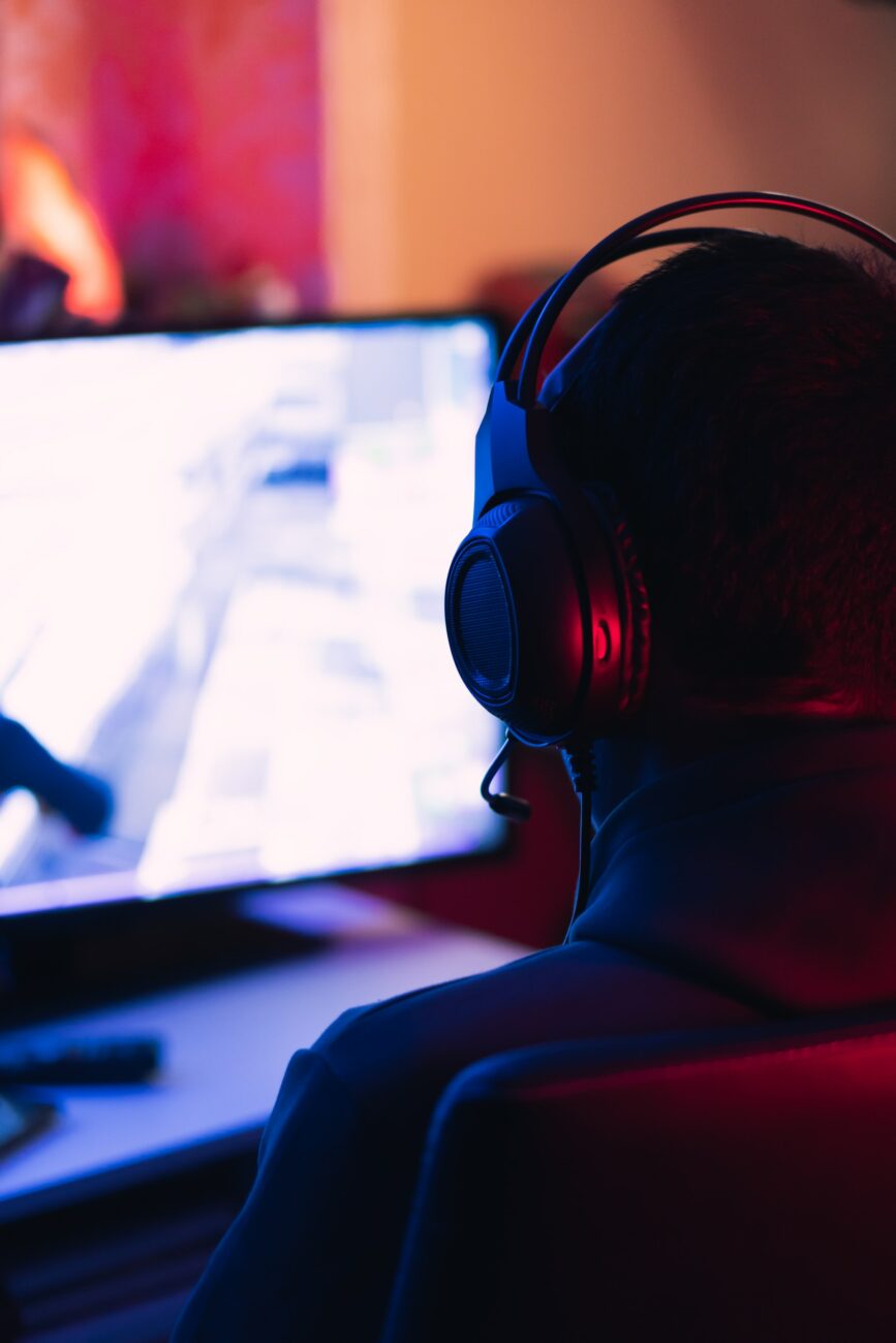 man in headphones looking at monitor