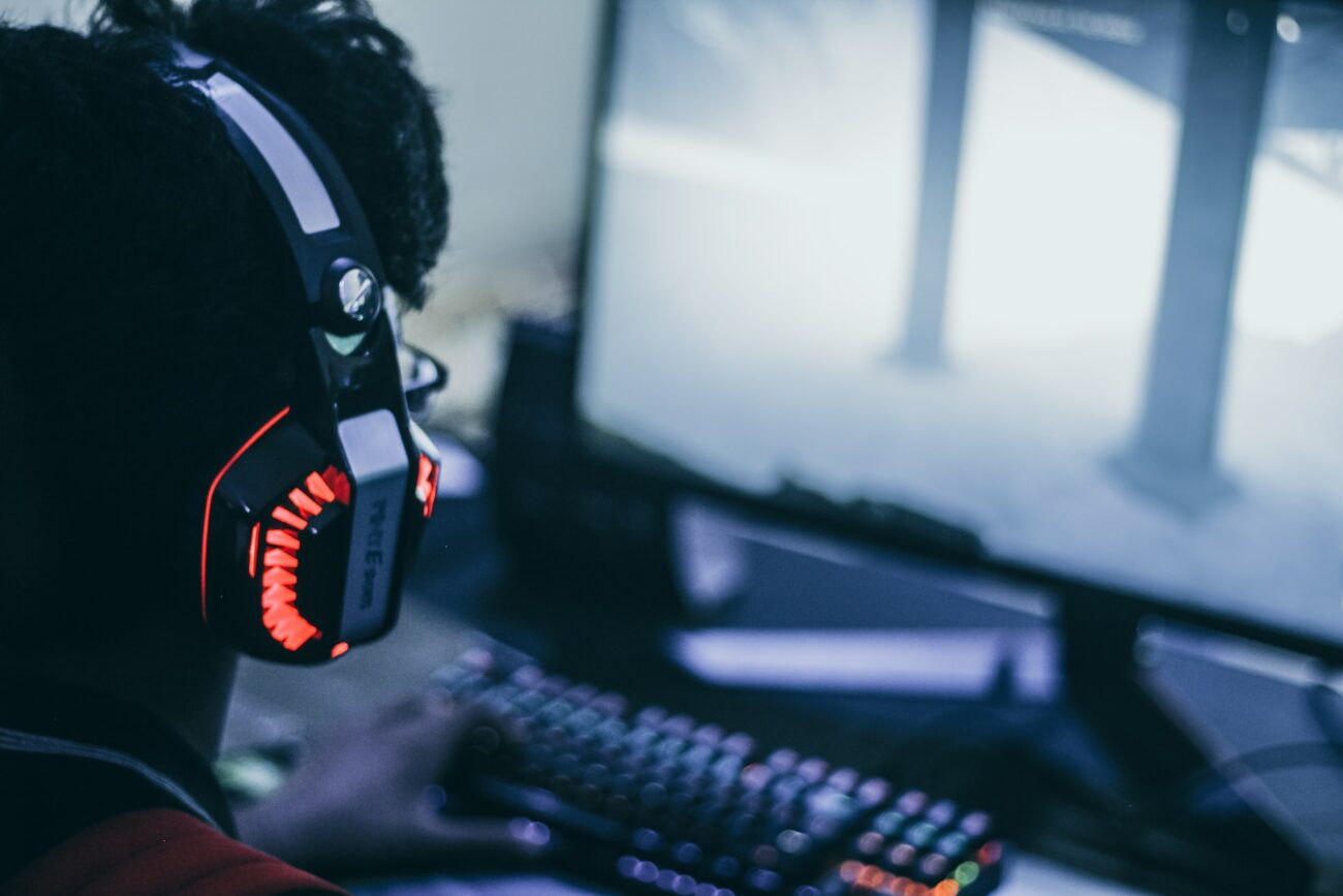 man in headphones looking at monitor