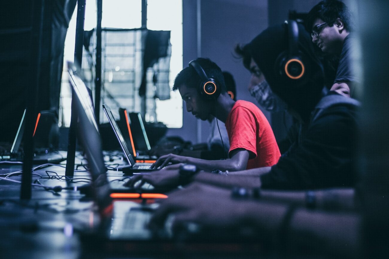 men in headphones looking at the monitor